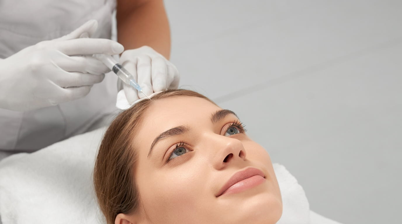 PRP injection being administered to the scalp during a hair treatment session